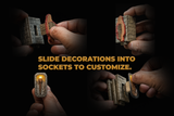 Four hands demonstrate a slide puzzle decoration by inserting it into different sockets against a black background, with gold text reading 'SLIDE DECORATIONS INTO SOCKETS TO CUSTOMIZE.'.