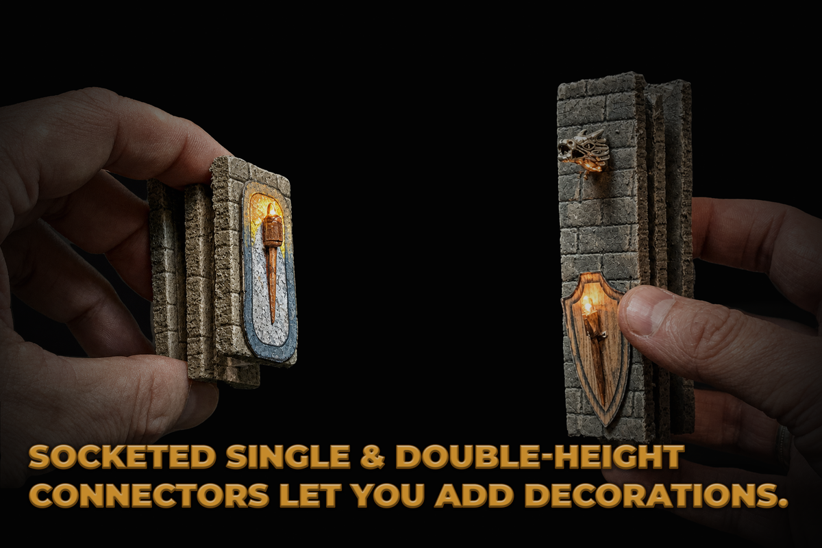 Two hands holding miniature stone wall connector pieces against a black background, with yellow text at the bottom reading 'SOCKETED SINGLE & DOUBLE-HEIGHT CONNECTORS LET YOU ADD DECORATIONS.'.